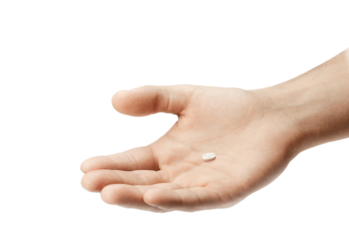 Hand holding ABILIFY MYCITE® (aripiprazole tablets with sensor) Tablet